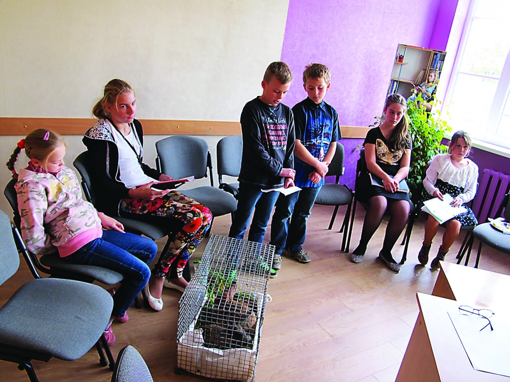 Kārķu mazpulka dalībnieki Ralfs Gavrilovs un Emīls Liepiņš (centrā) guvuši labu pieredzi biškopībā.                                                                   
Autors:  ALDIS DUBĻĀNS