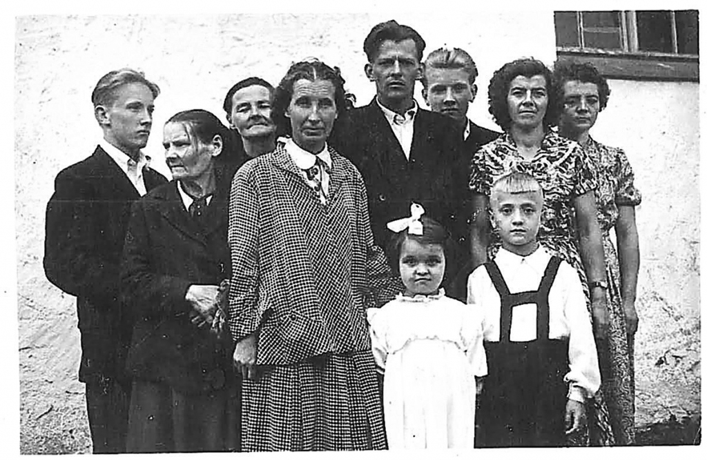 Drīz pēc pārrašanās mājās bērnunamos uzaugušo Turaldu un Raimondu Dziļumus kristīja, lai noņemtu bērniem visu slikto. Viņu mamma politiski ieslodzītā Velta Dziļuma {pirmā no labās) pēc atgriešanās no soda nometnes dēlu un meitu no bērnunamiem varēja izņemt tikai tad, kad bija atradusi darbu un dzīvokli. Faktiski bērnus uzaudzināja viņu vecmāmiņa Kristīne Dziļuma (trešā no kreisās).                                                
Autors:  NO DZIĻUMU ĢIMENES ARHĪVA