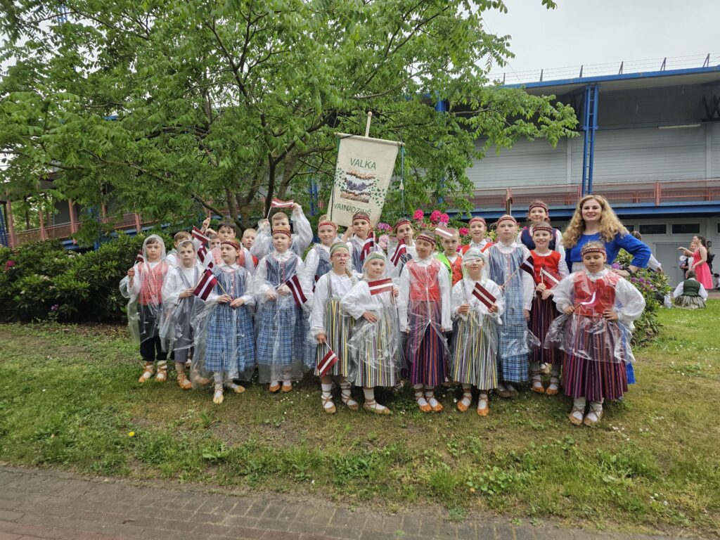 Tautas deju kolektīvam “Vainadziņš” prieku svētku gājienā nespēja sabojāt pat negaiss.